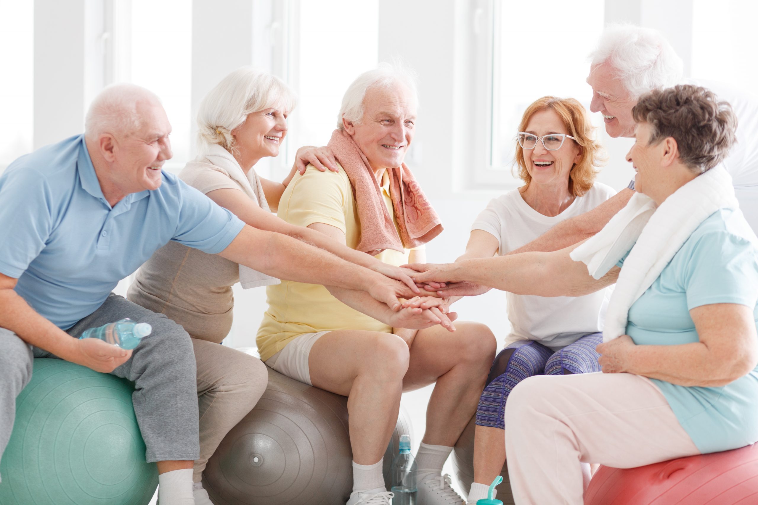 Happy active senior people congratulations each other for workout